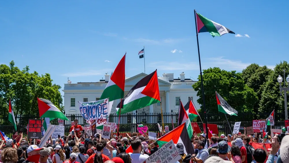 Protesters gather outside the White House waving Palestinian flags. Shutterstock