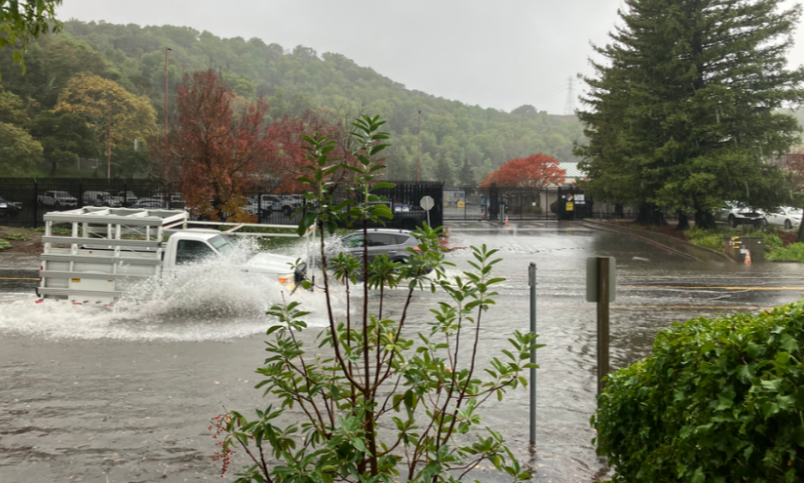 truck driving through a flooded street