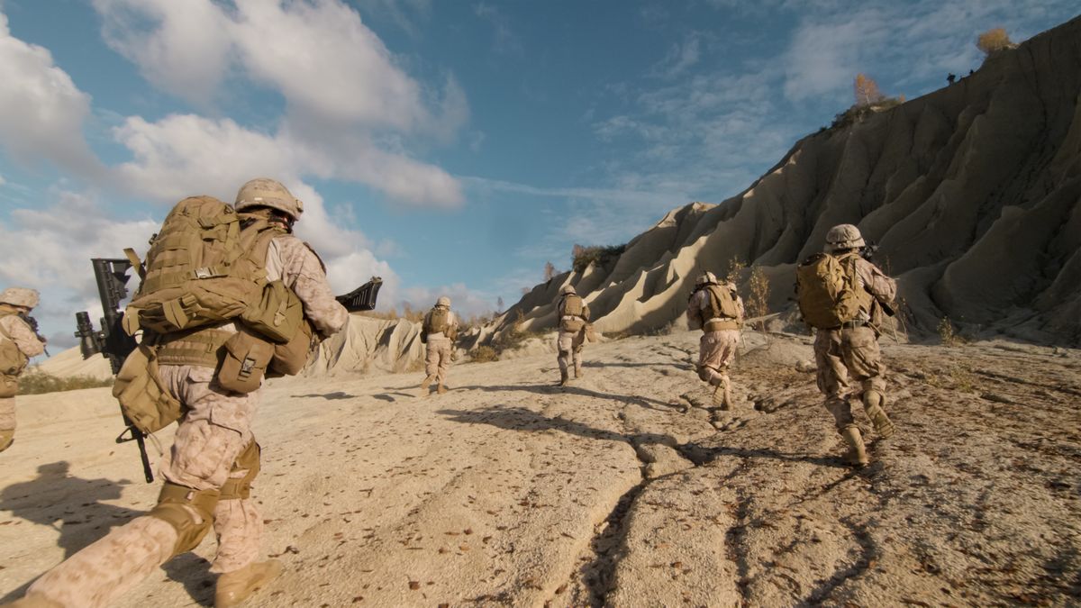 Soldiers running across Syrian desert.