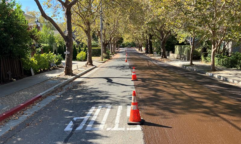 Street halfway repaved with cones in the middle