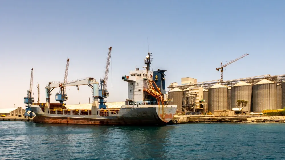 A container ship is loaded with cargo in Port Sudan.  Shutterstock